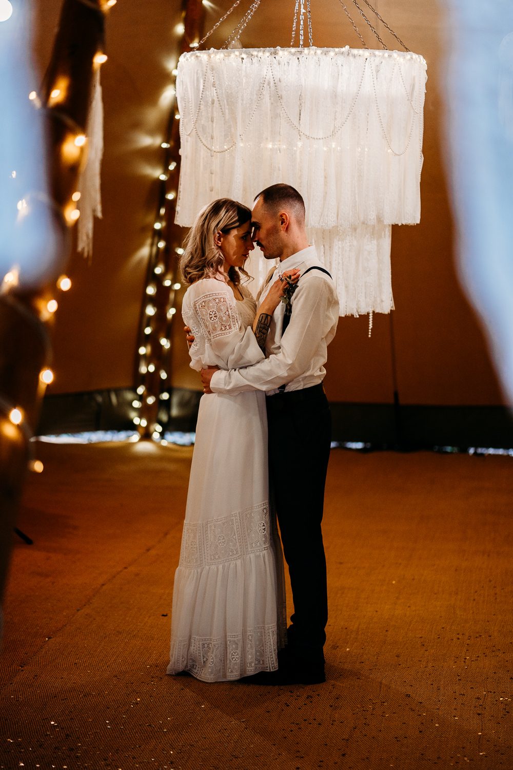 BRIDE AND GROOM DURING FIRST DANCE IN WEDDING TIPI
