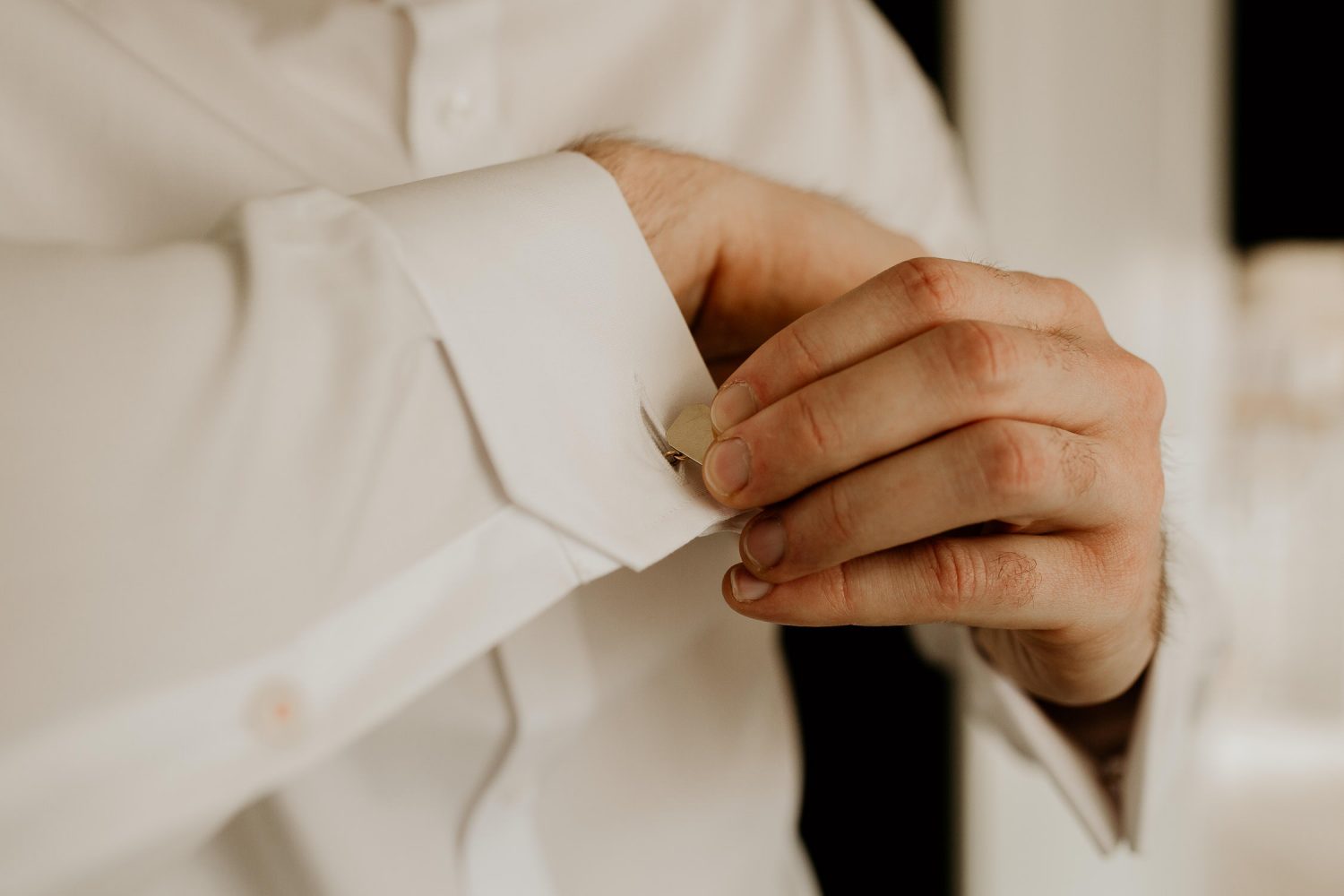 luxury manor house hotel wedding groom attaching cufflinks