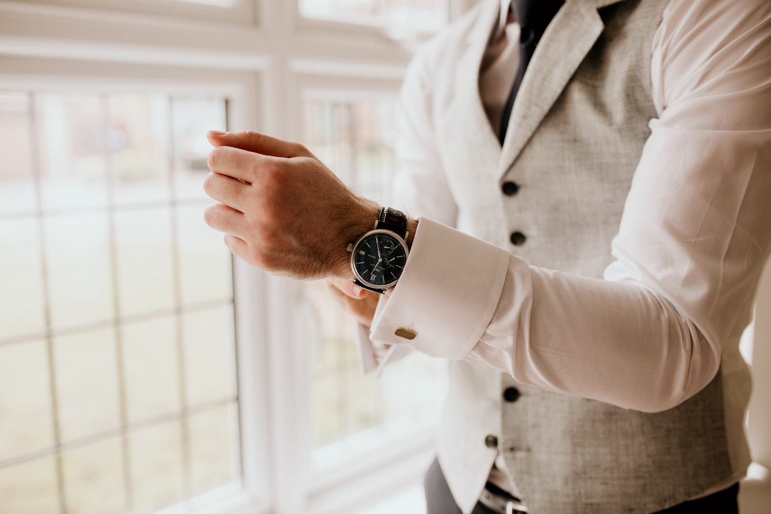 luxury manor house hotel wedding groom getting ready before wedding wearing new watch