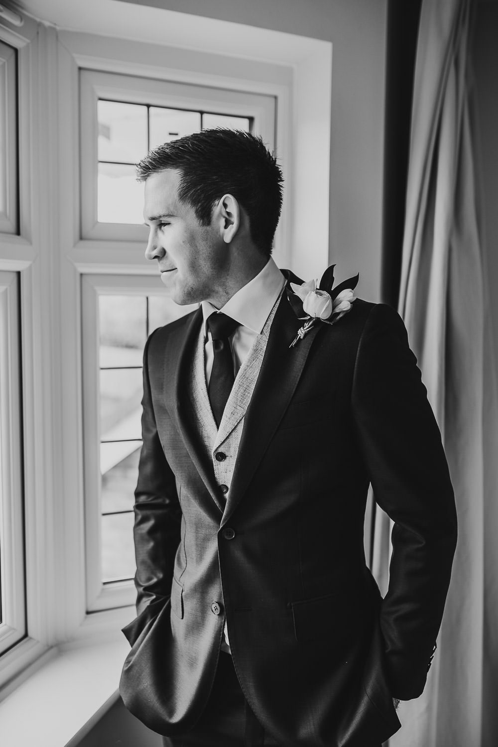 luxury manor house hotel wedding groom and grooms men getting ready black and white groom smiling