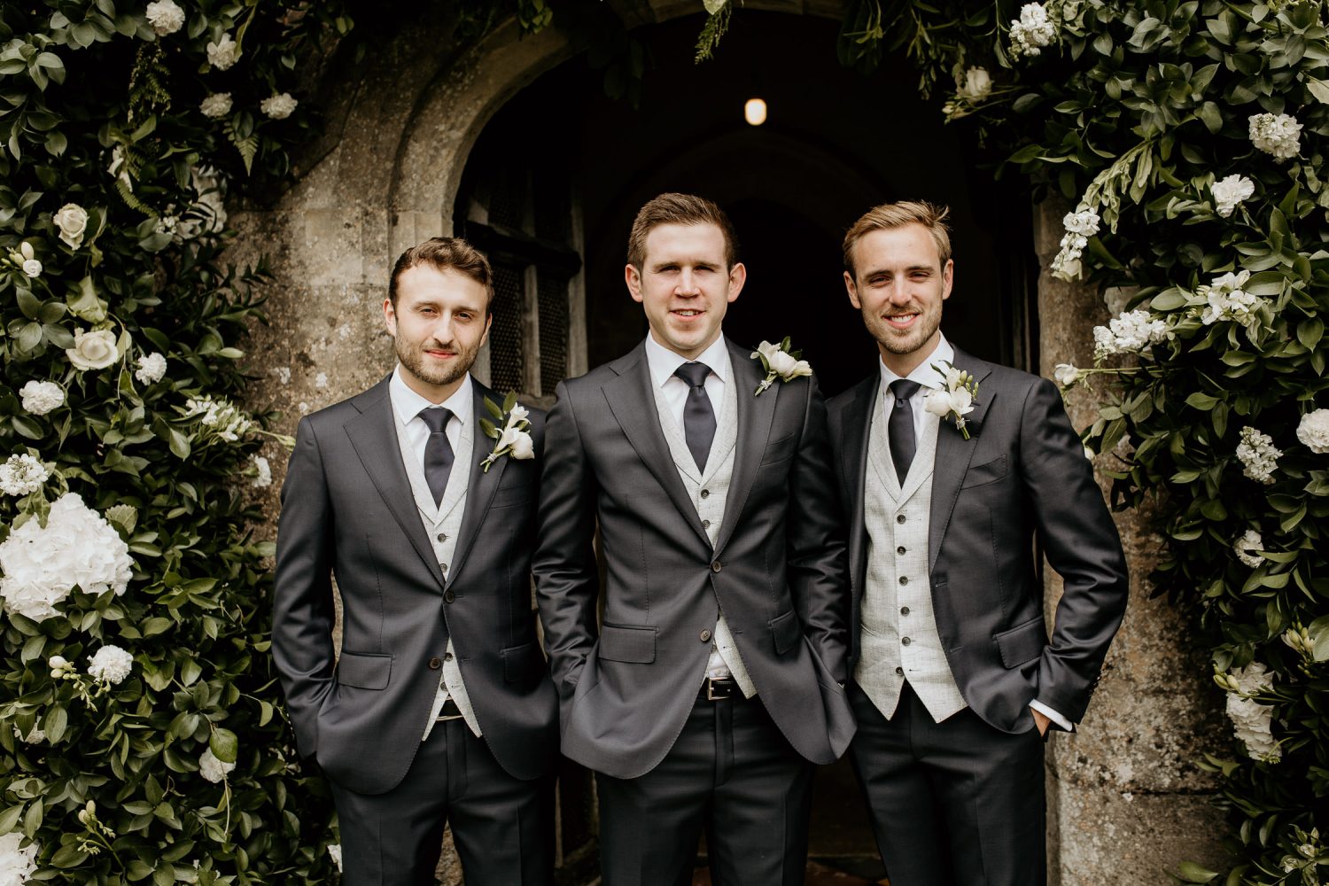 luxury manor house hotel wedding groom and grooms men outside with flowers