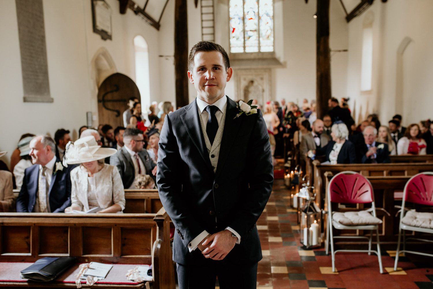 luxury manor house hotel wedding groom and guests wait for the bride at the alter