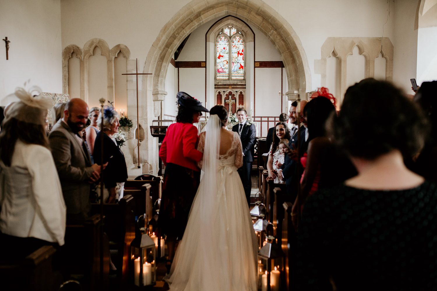luxury manor house hotel wedding bride walks down the aisle of the church to her awaiting groom