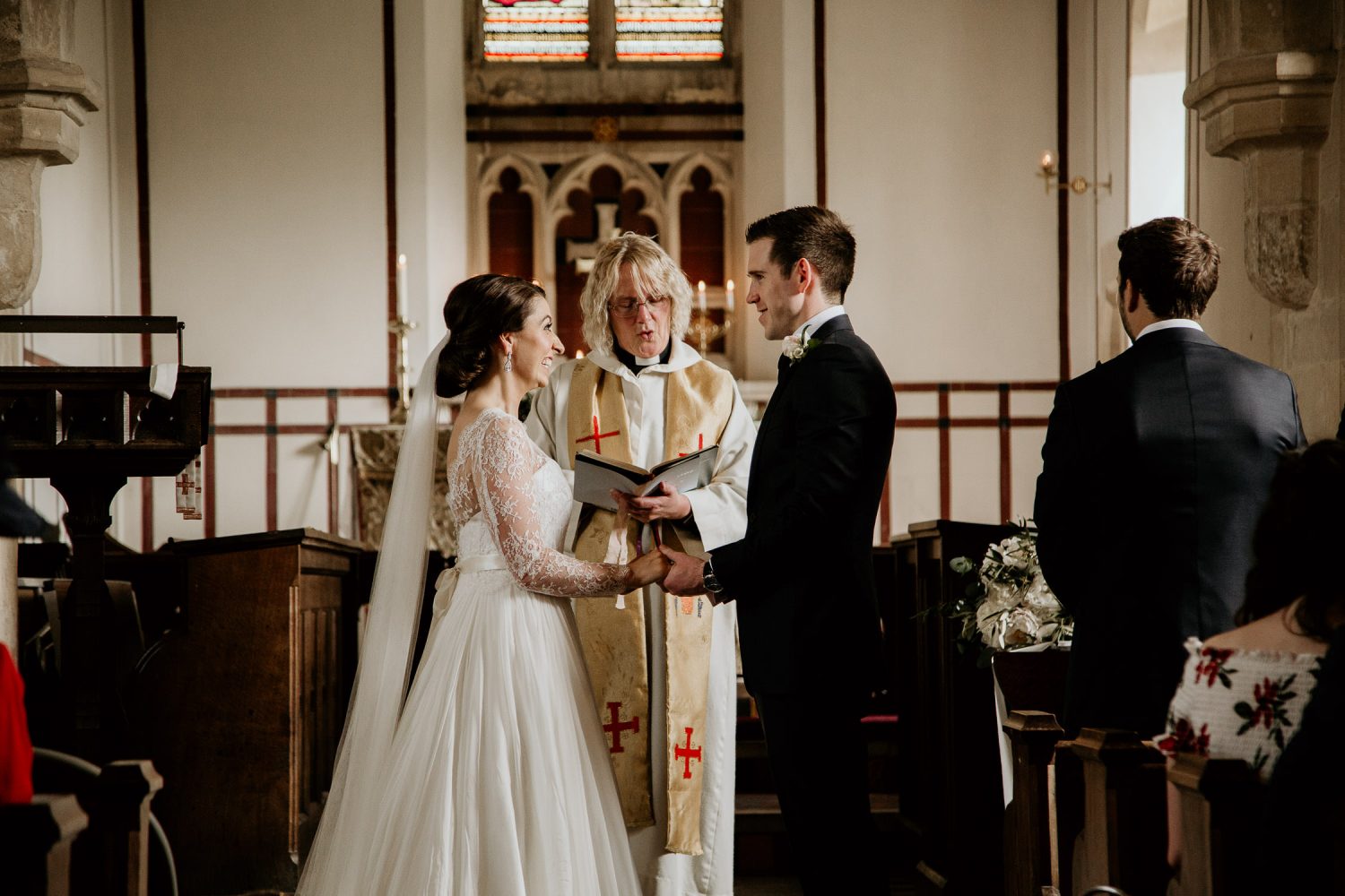 luxury manor house hotel wedding bride and groom looking at each other as they take their vows