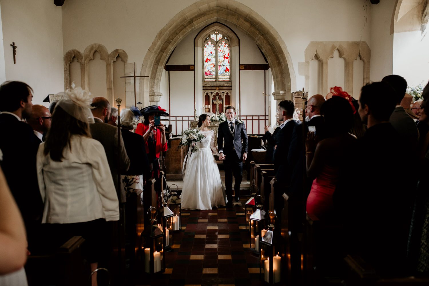 luxury manor house hotel wedding bride and groom walk down the aisle, past their guests, as husband and wife