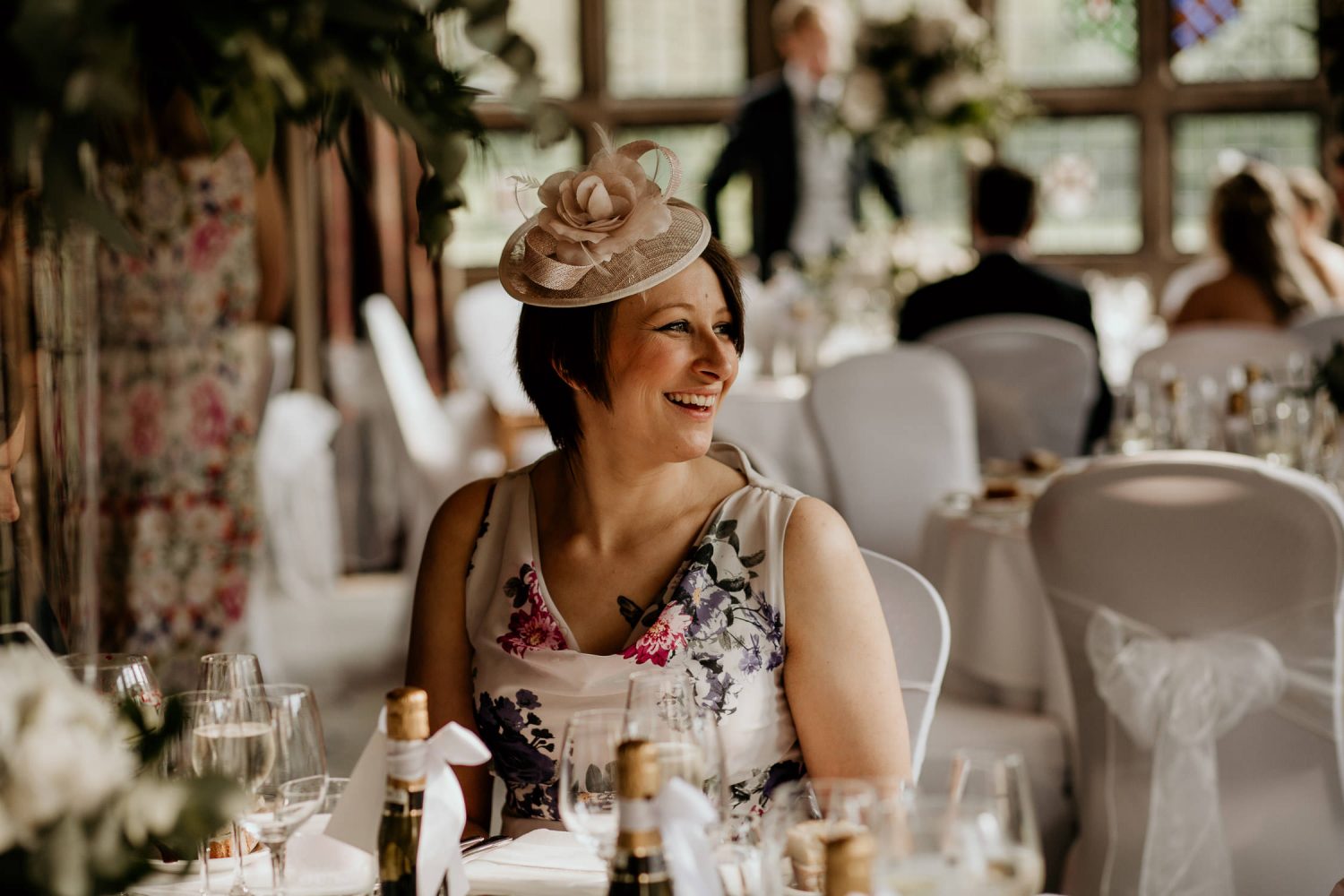 luxury manor house hotel wedding laughing wedding guest seated at the table