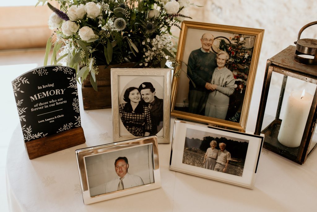 personalised wedding decorations table with photos of relatives in loving memory