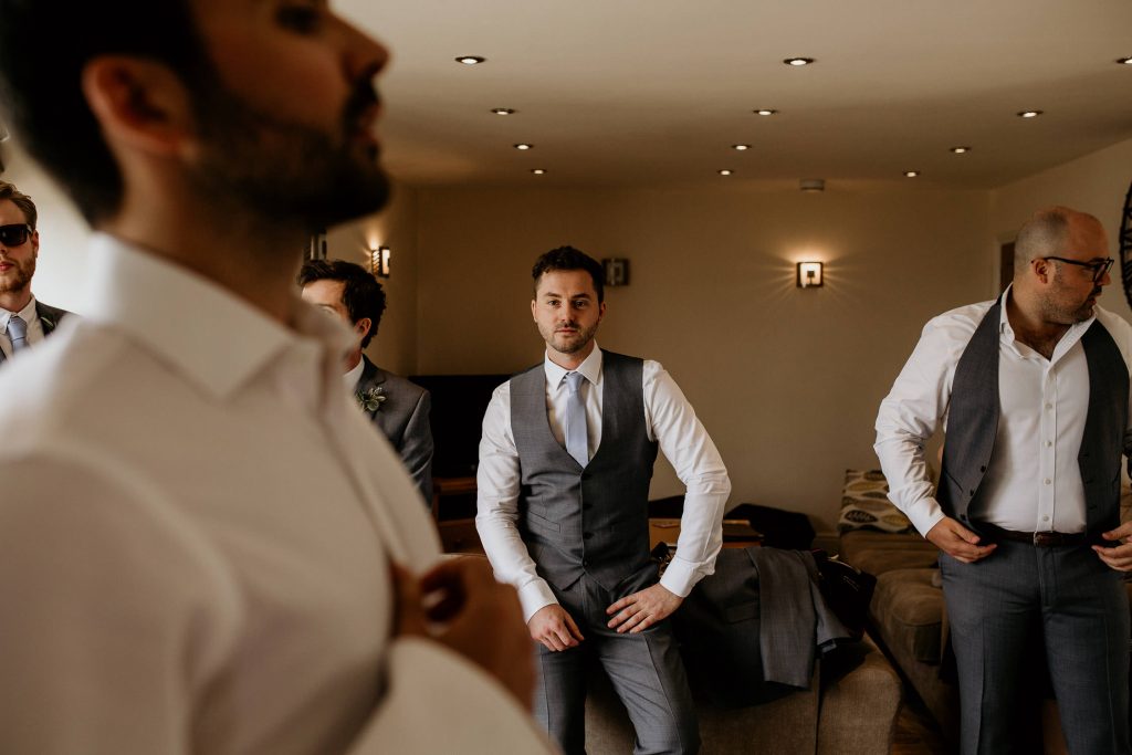 grooms and groomsmen get ready on the morning of the wedding