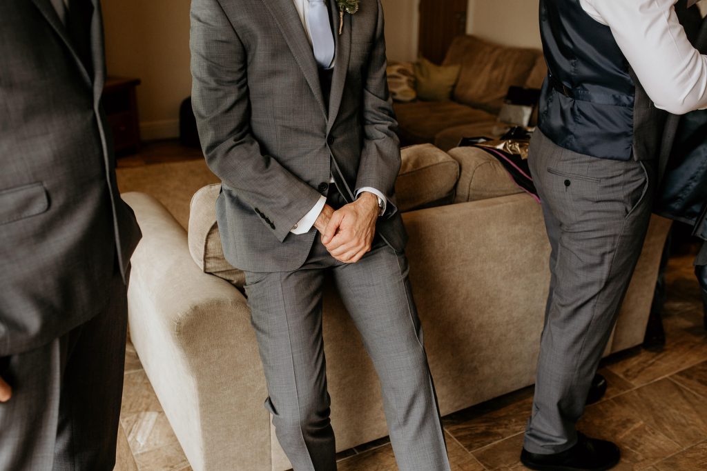 close up of high end luxurious grey grooms man suit