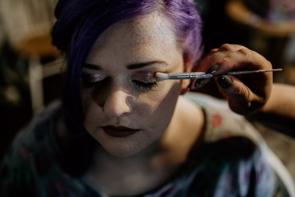 elegant photo of quirky alternative bride having her wedding make up applied