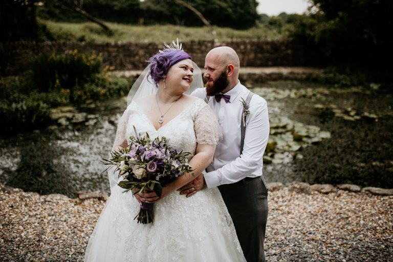 quirky alternative wedding bride and groom outside day time country side location