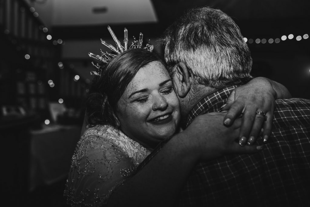 emotional photo of bride greeting wedding guests