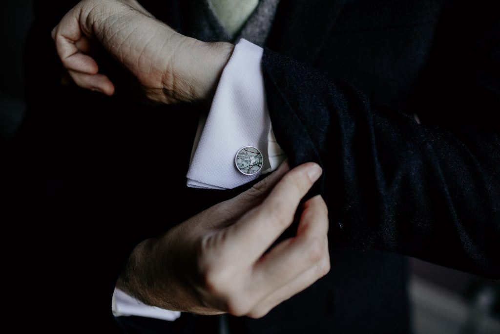 close up of grooms map themed wedding cufflinks