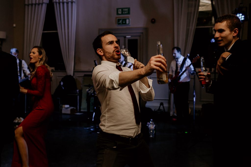 happy and relaxed photo of wedding guests enthusiastically dancing