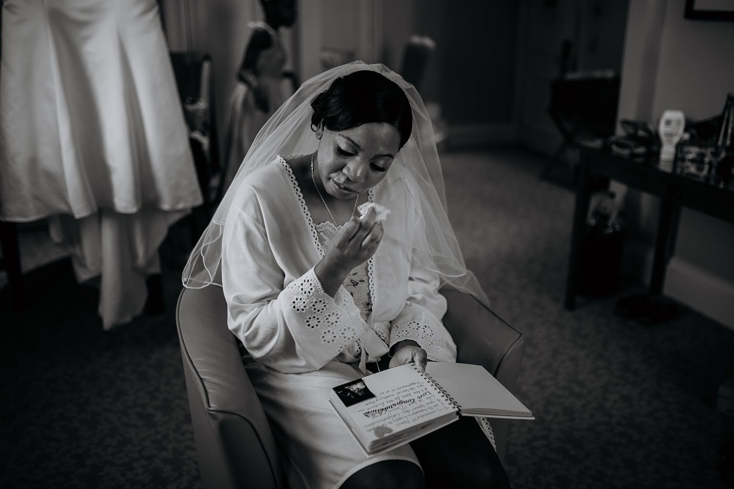 emotional black and white photo of the bride crying as she read a personalised book