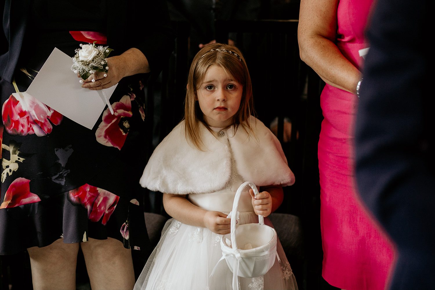 close up of flower girl in white dress