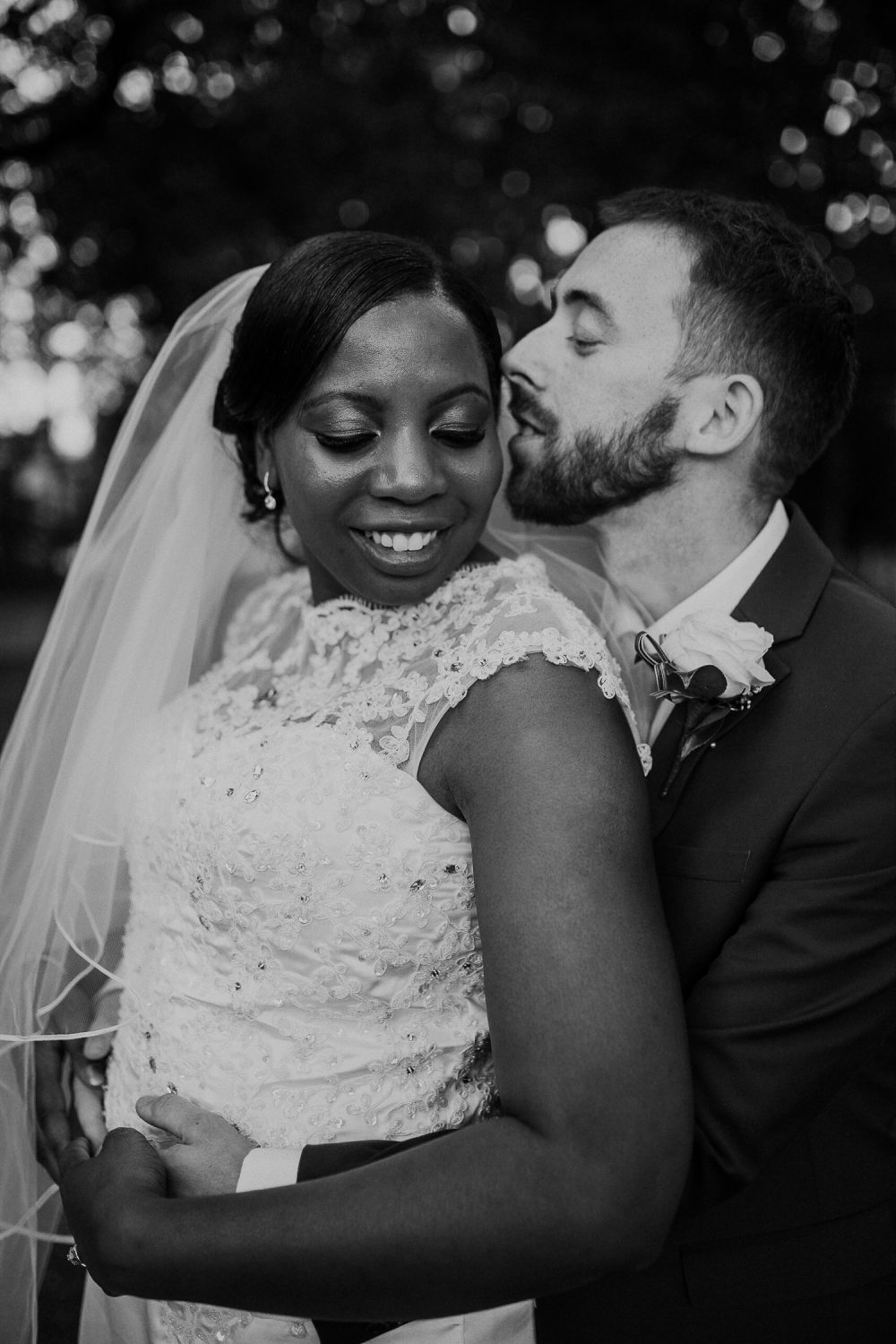 black and white personal photo of bride and groom embracing