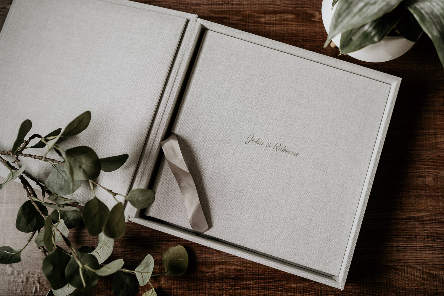 Flat lay of grey fine art wedding Photography album