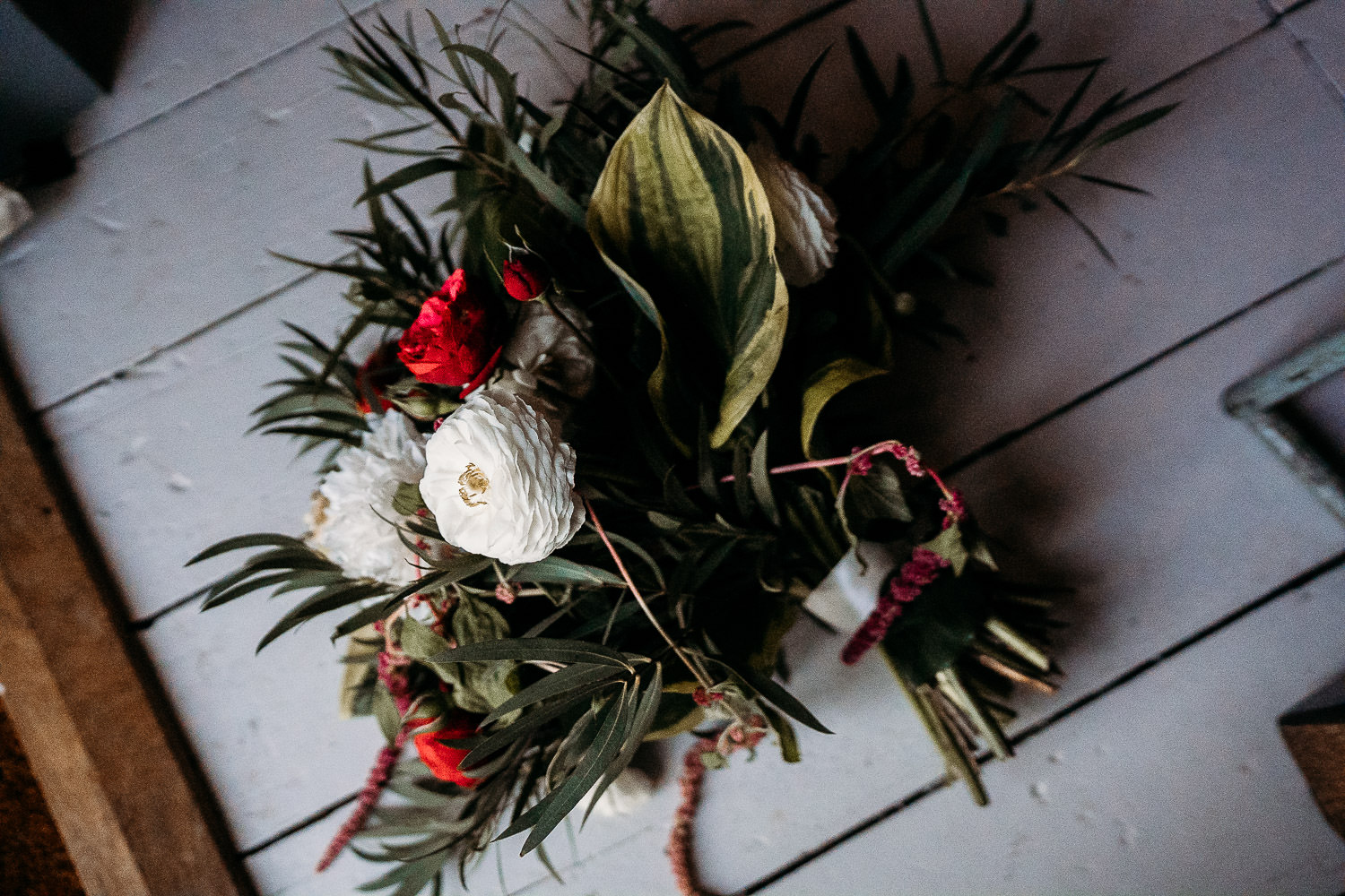 hand tied wedding bouquet with red floral elements