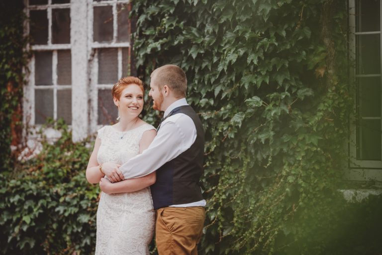 bride and groom cuddling outside of the mercure hotel in elcot