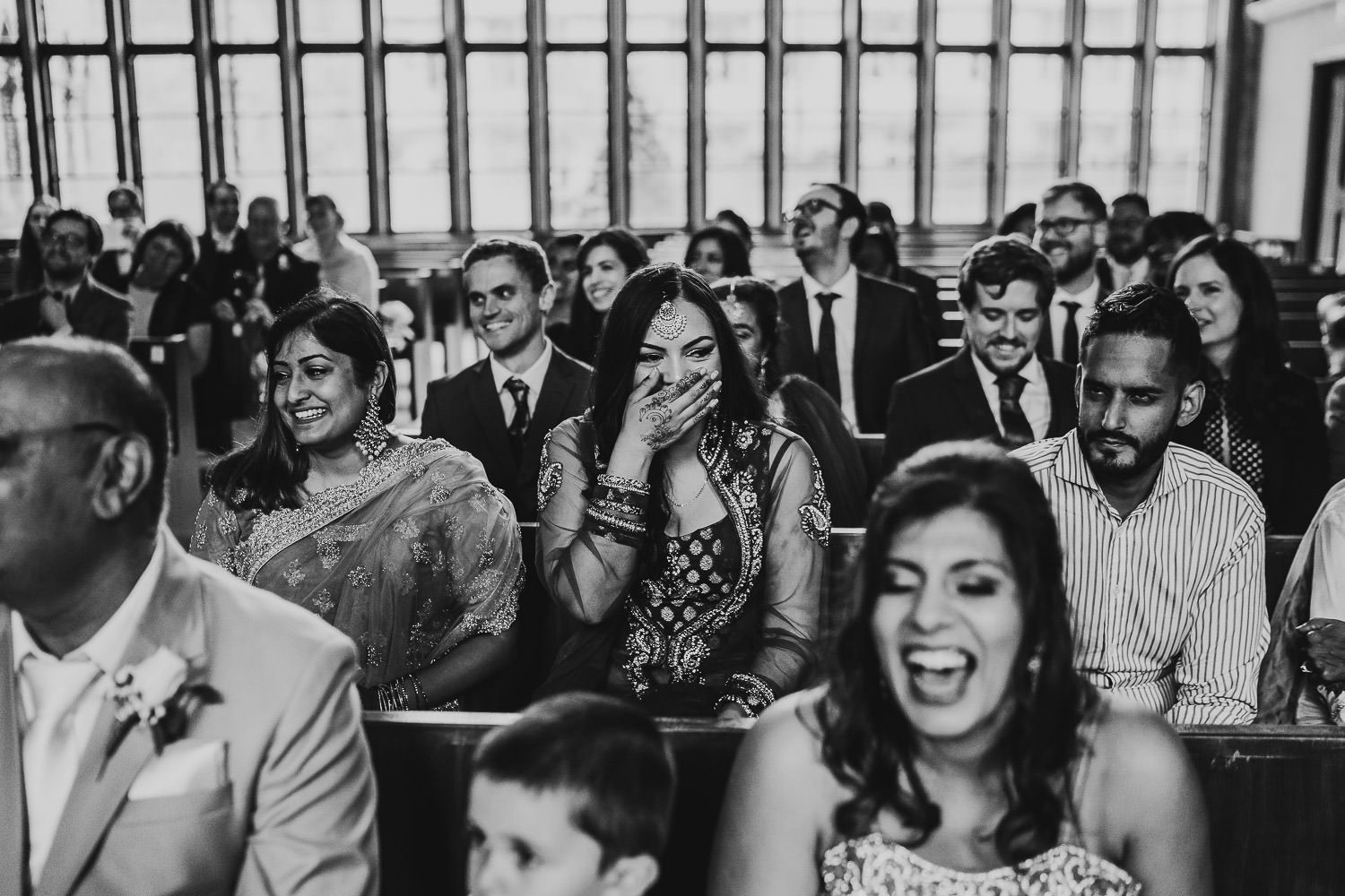 wedding guest laughing during indian wedding ceremony