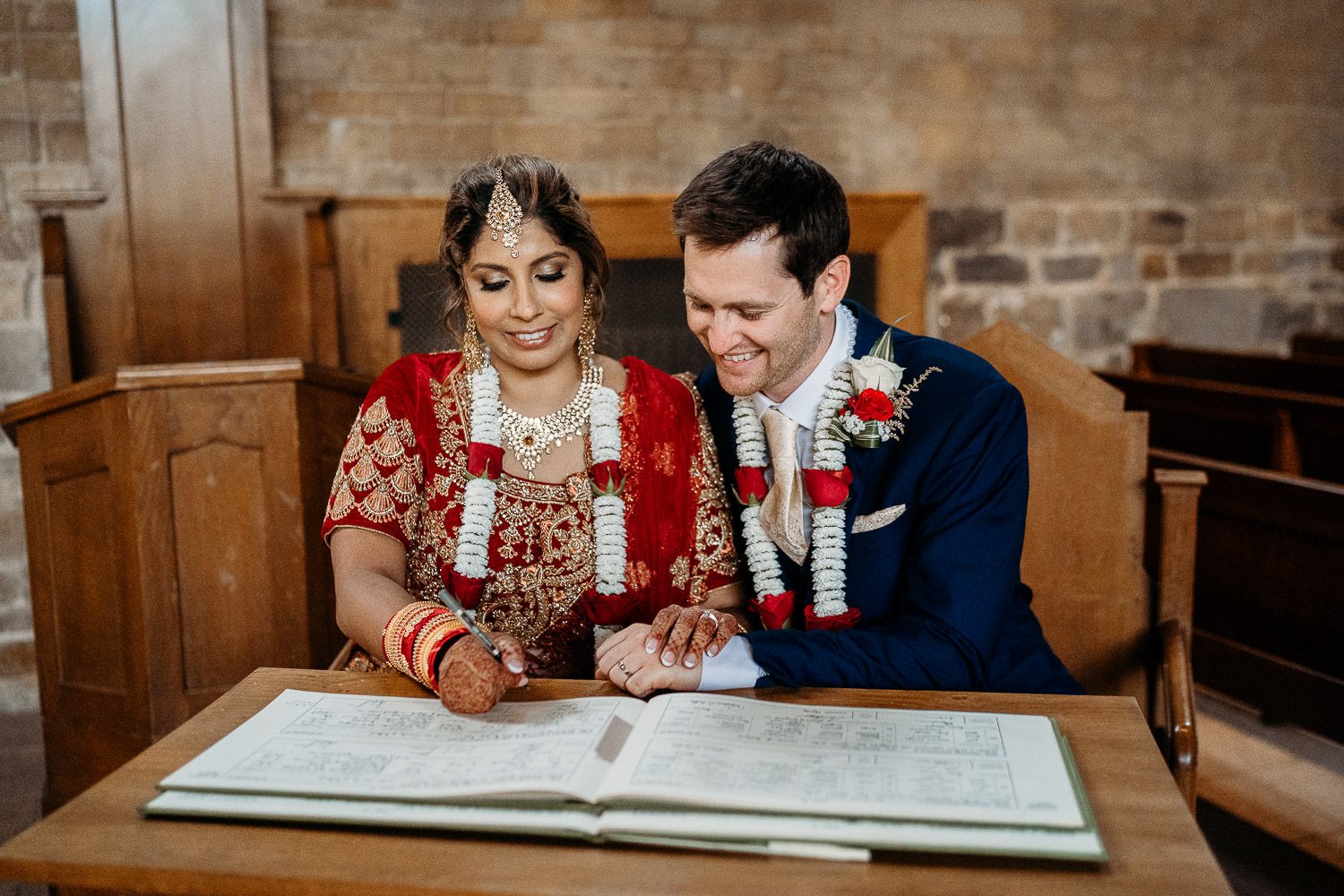 bride and groom signing register at indian wedding
