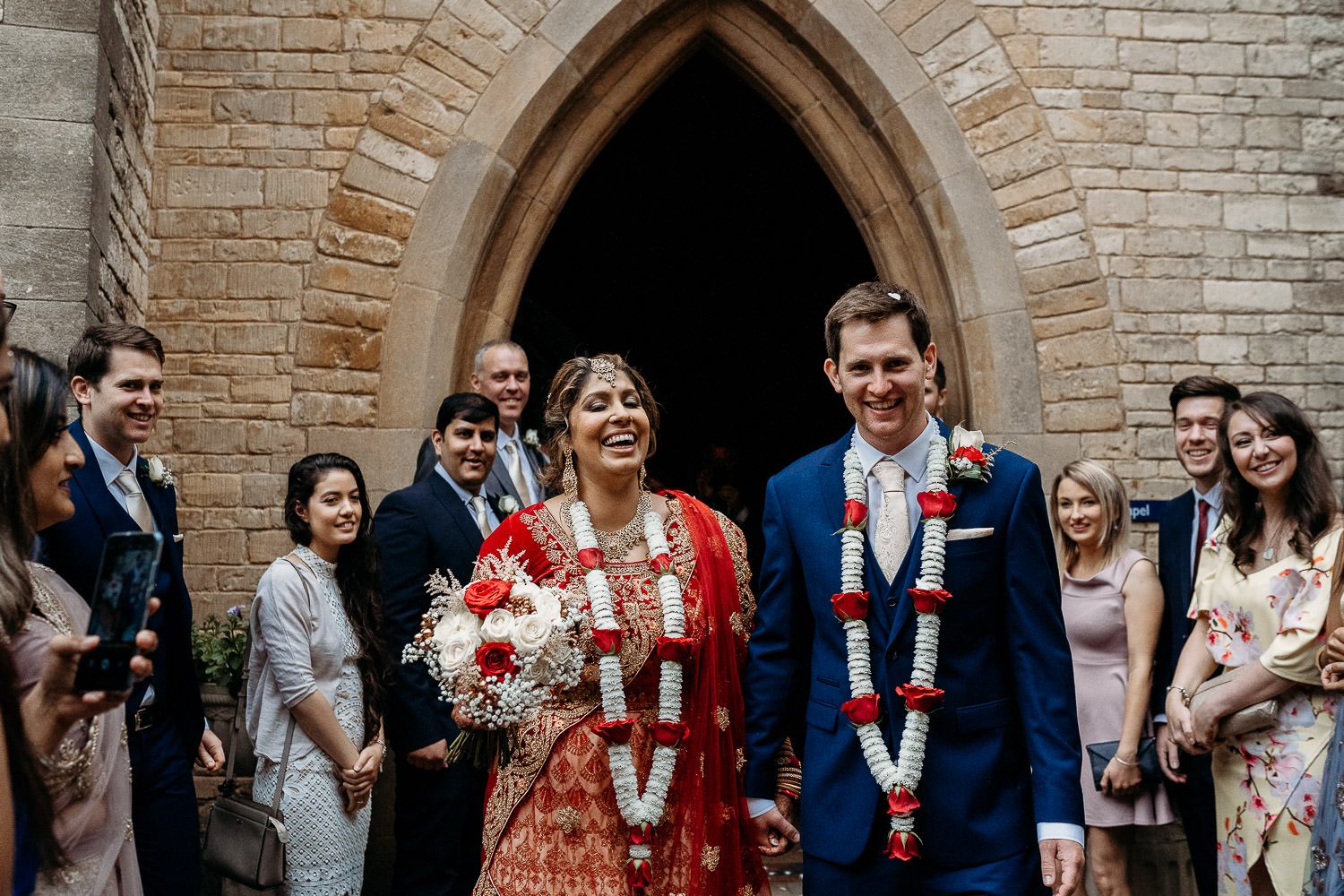 bride and groom laughing during confetti throwing