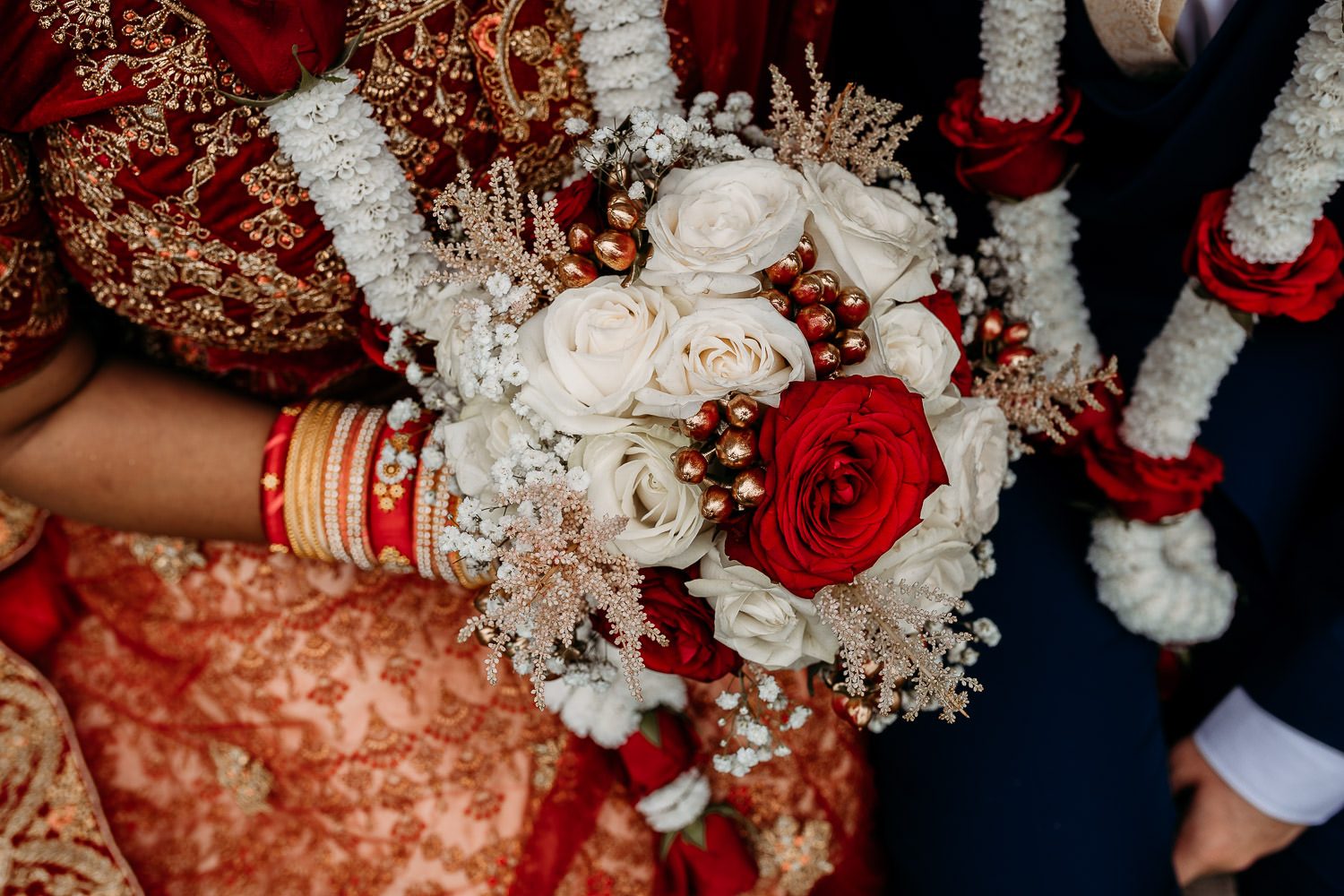 close up of brides red and white rose wedding bouquet