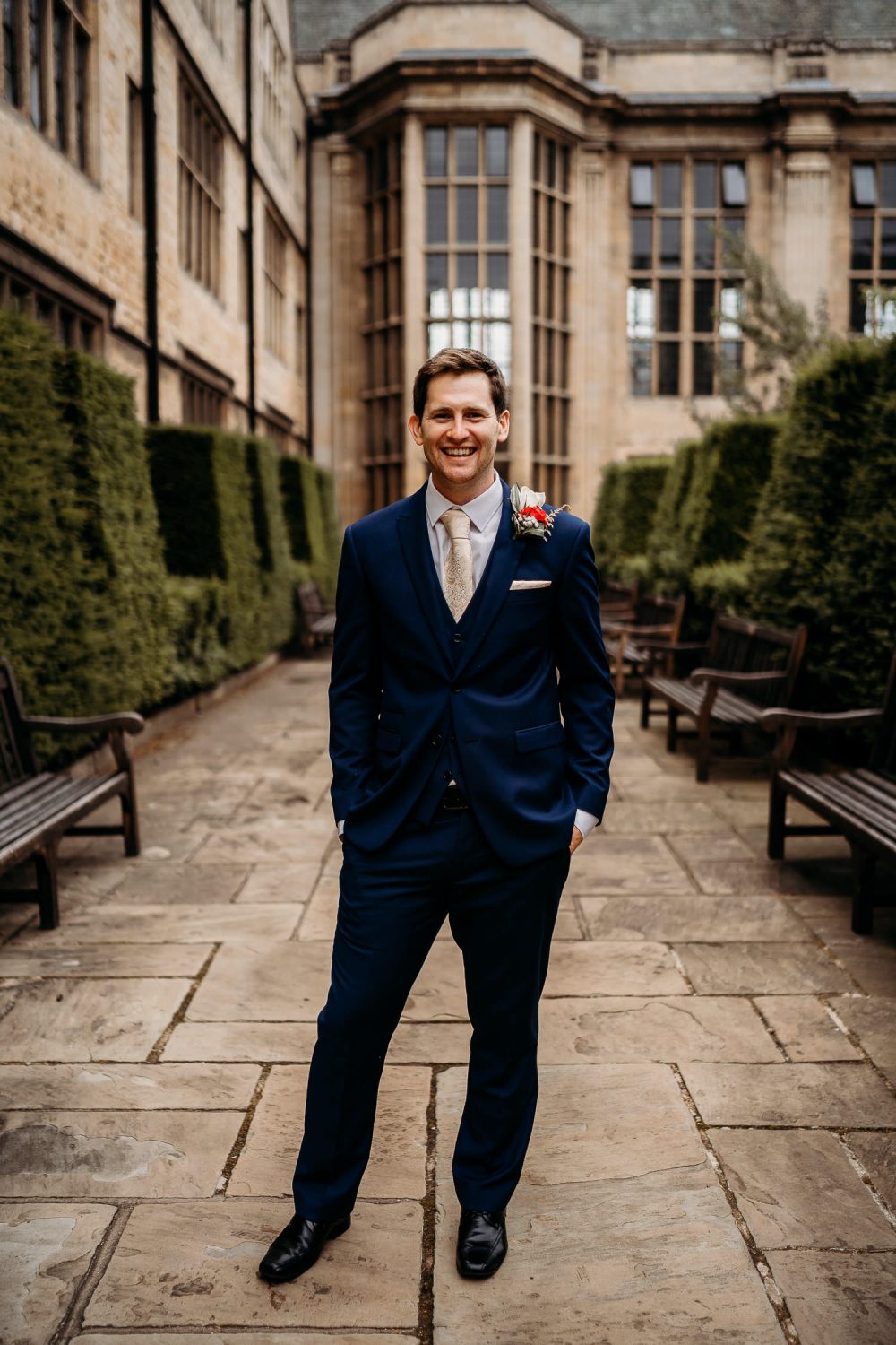 groom smiling outside uppingham chapel