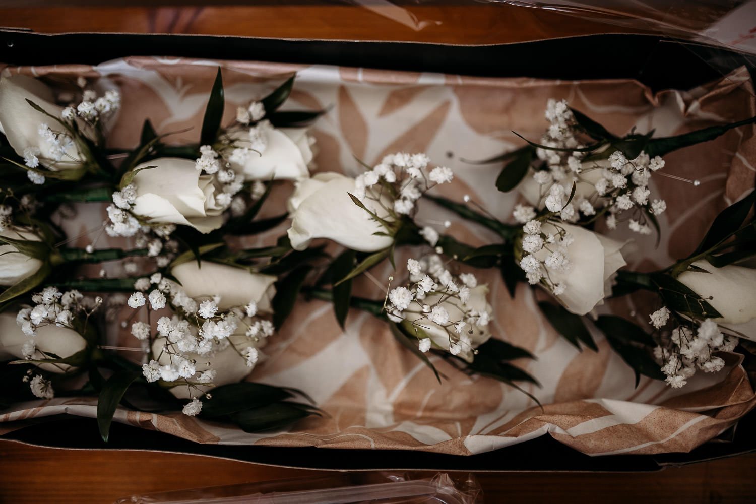 close up of rose and gypsophila buttonholes