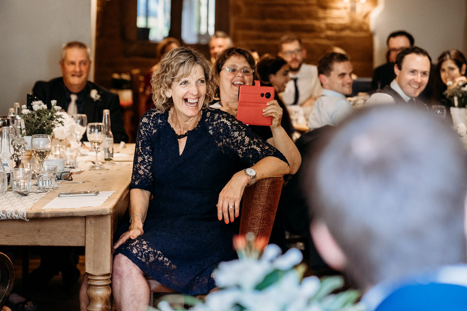 groom's mother laughing during speeches