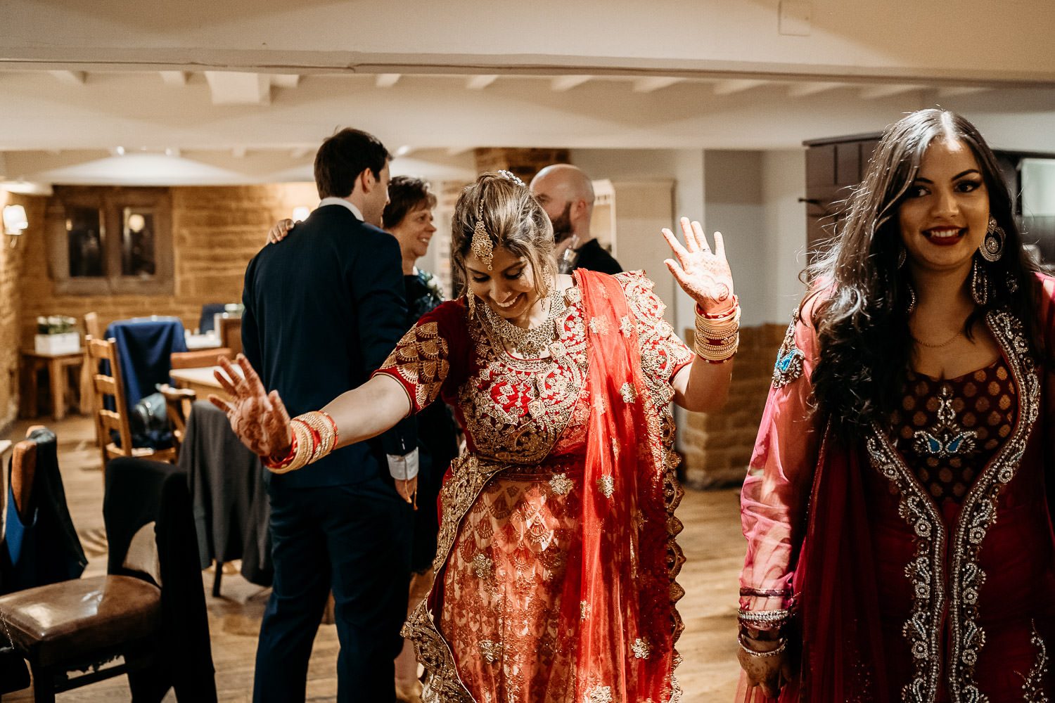 asain bride in red sari dancing