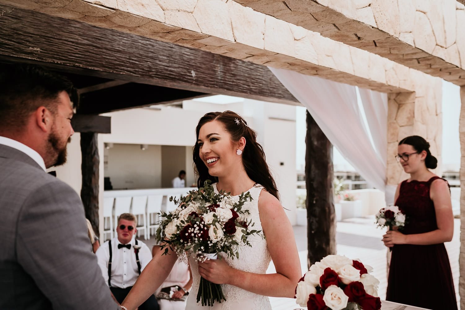 bride smiling at groom during cancun wedding ceremony 