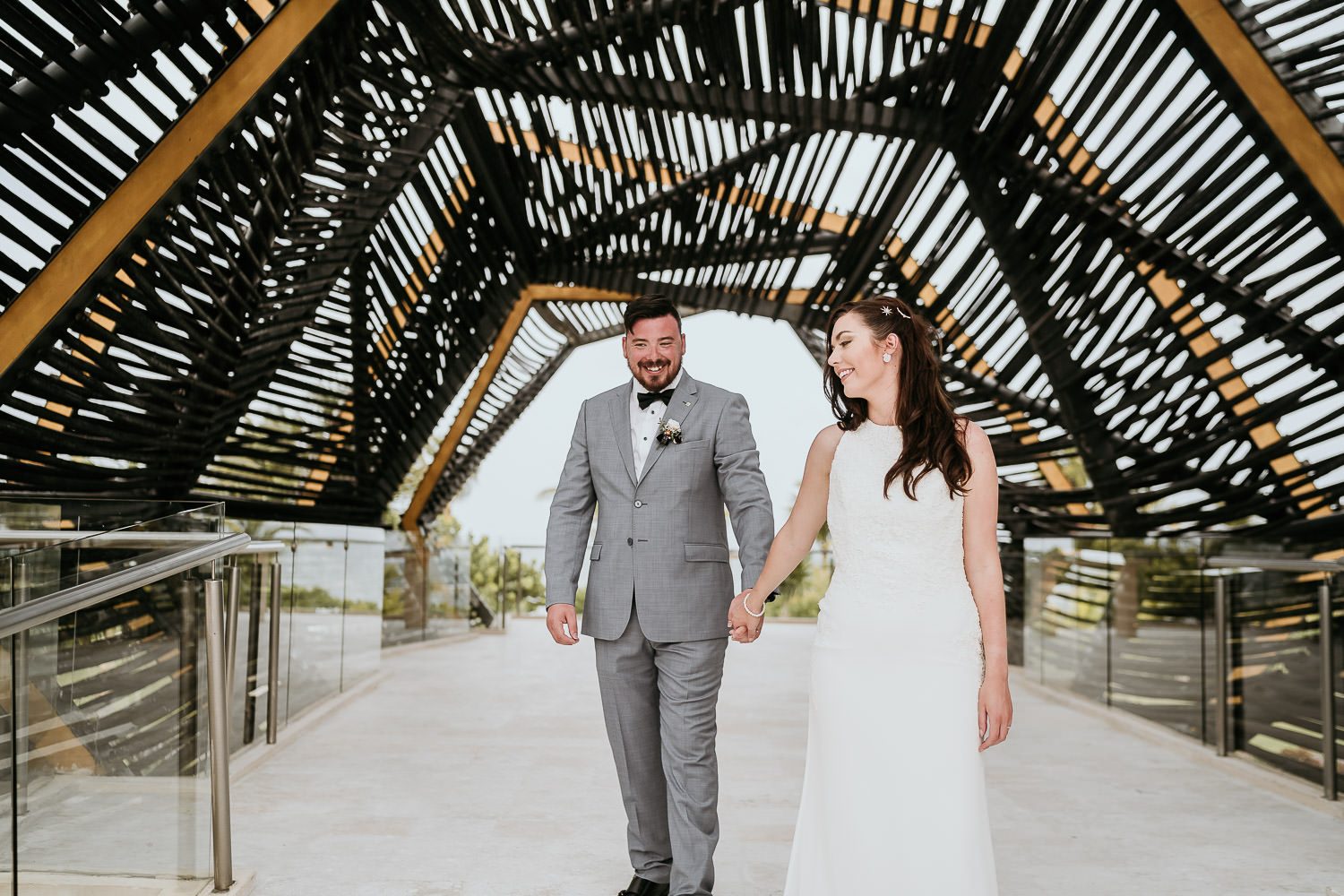 bride and groom walking through the royalton riviera gazebo
