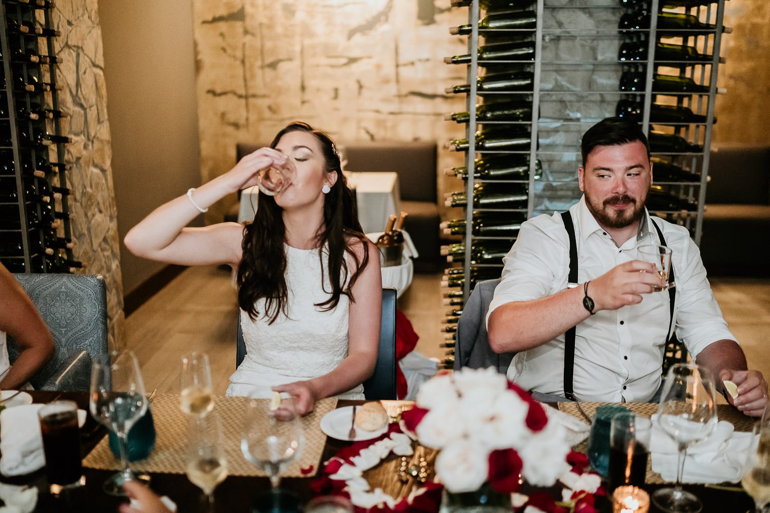 bride and groom having tequila shots during destination wedding in mexico