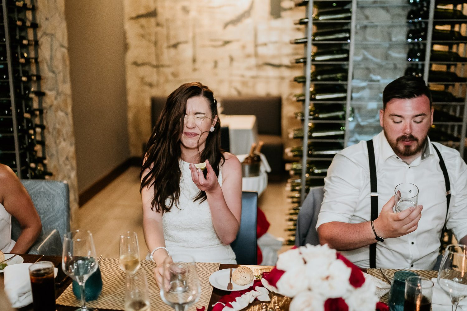 bride and groom drinking tequila at destination wedding reception in cancun