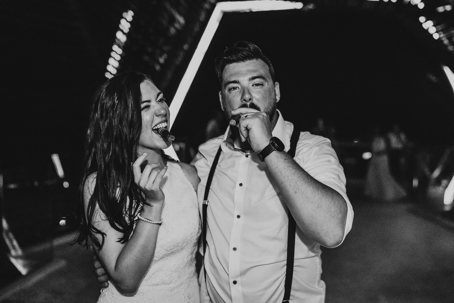 bride and groom smoking cigars in mexico