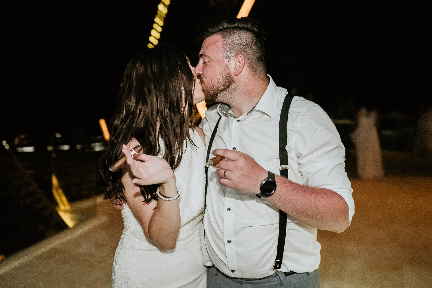 bride and groom smoking cigars in cancun
