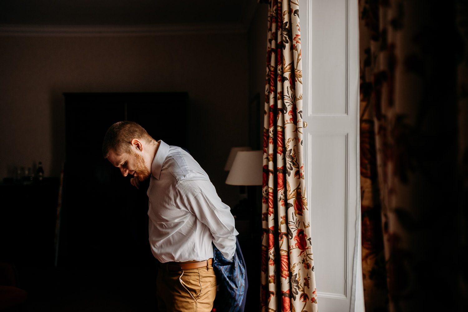 groom getting ready in mercure elcot bridal suite
