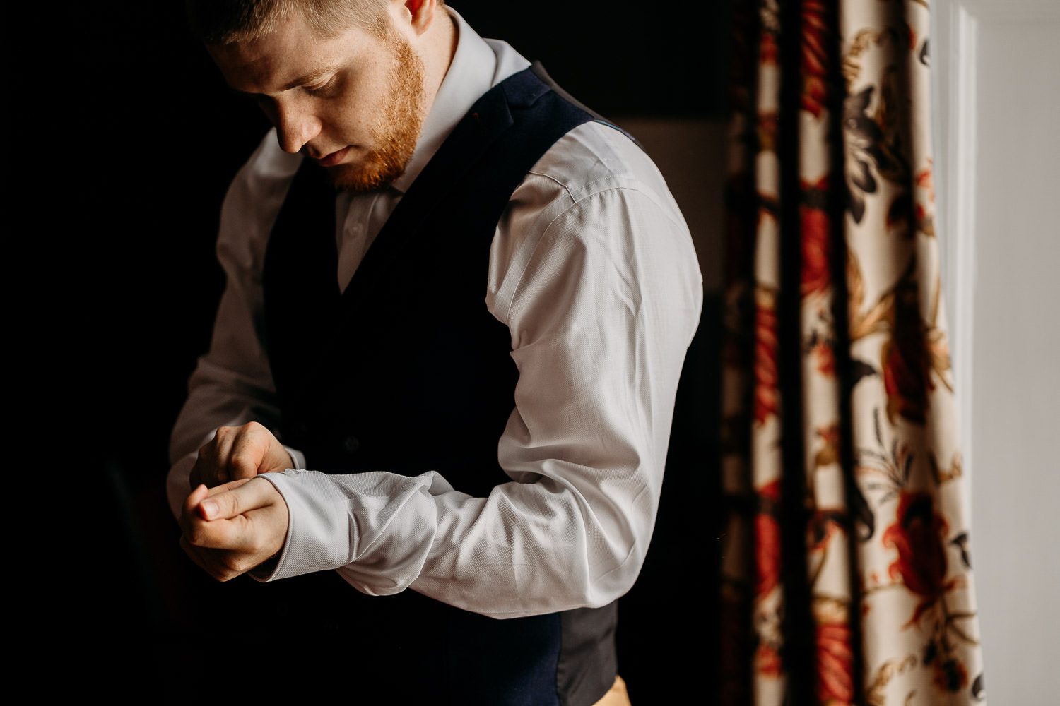 groom adjusting cufflinks in newbury hotel room