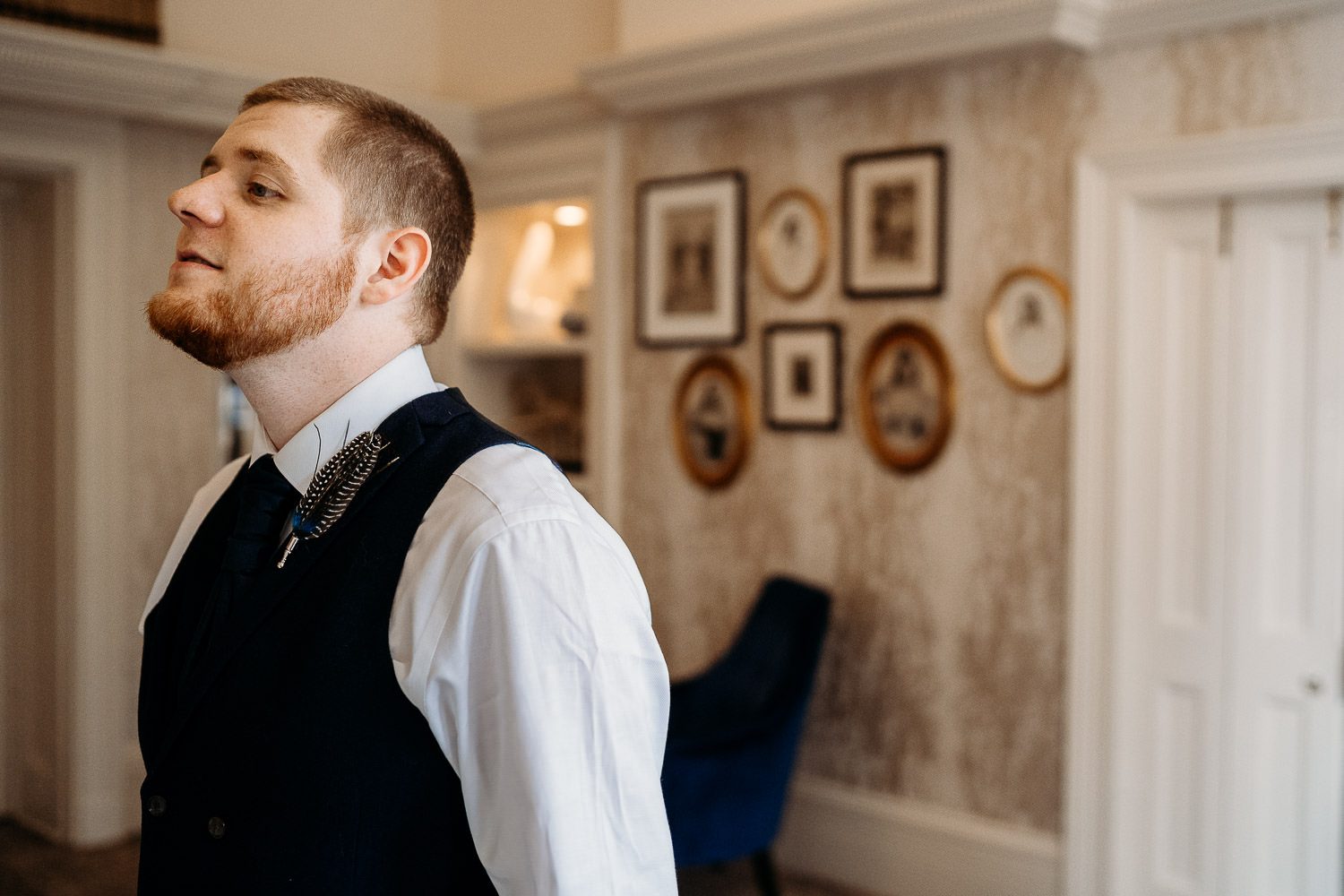 groom waiting for bride to come in during first look at mercure elcot hotel