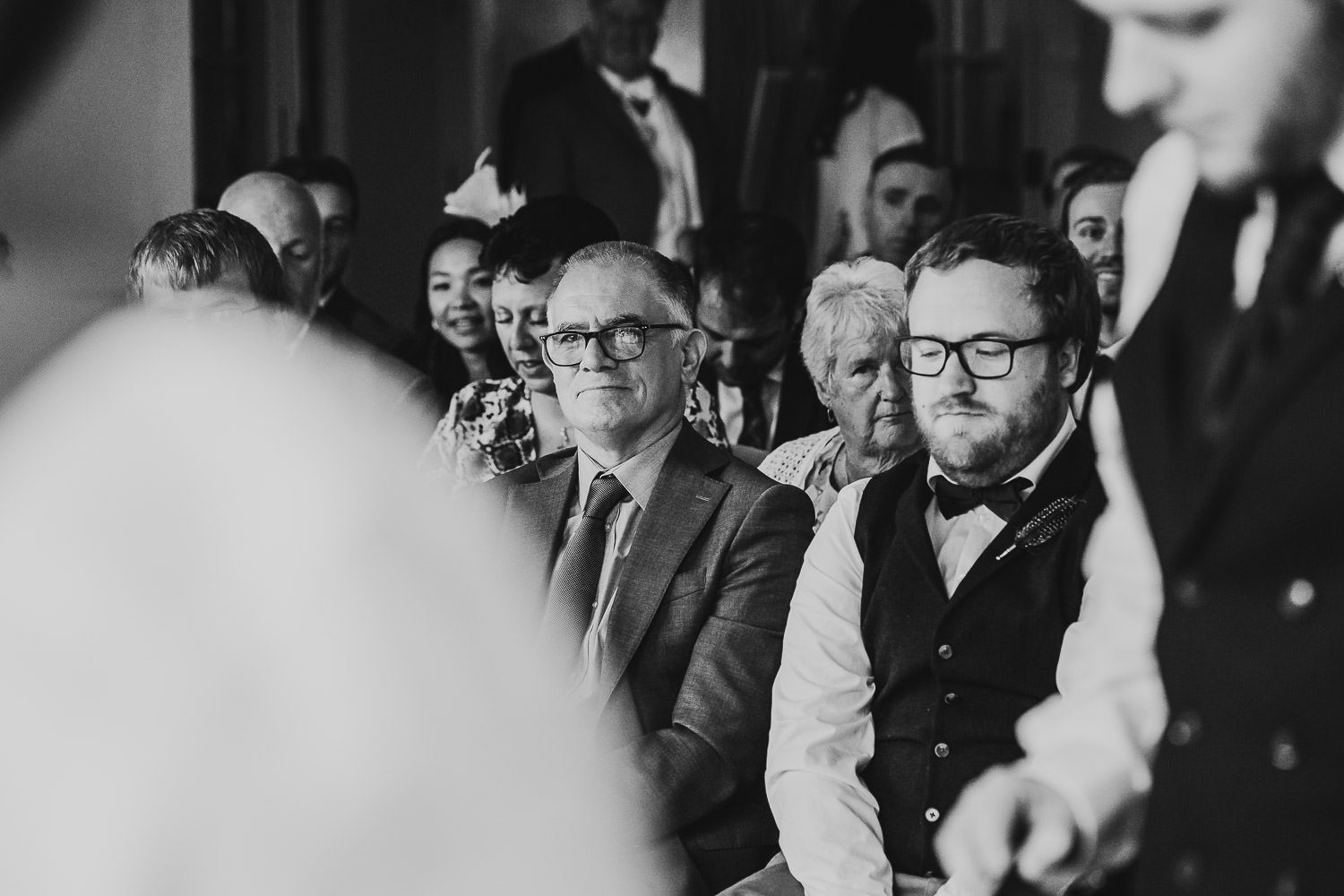 father of groom smiling during wedding ceremony