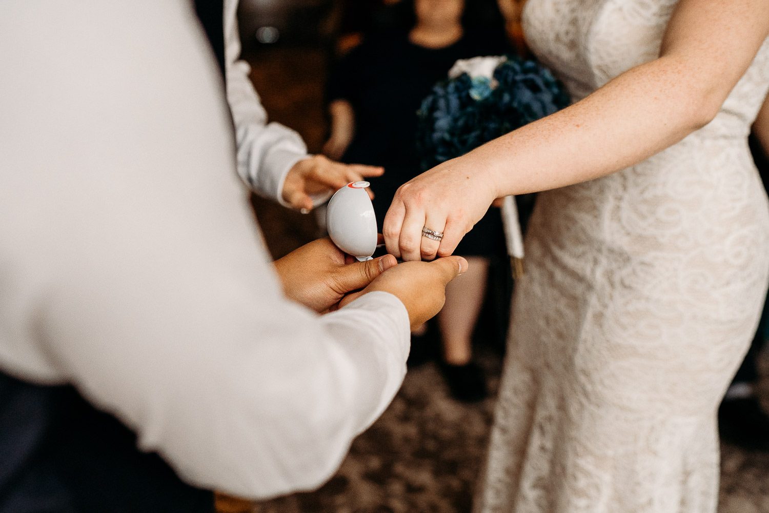 bride taking ring out of pokemon pokeball ring holder