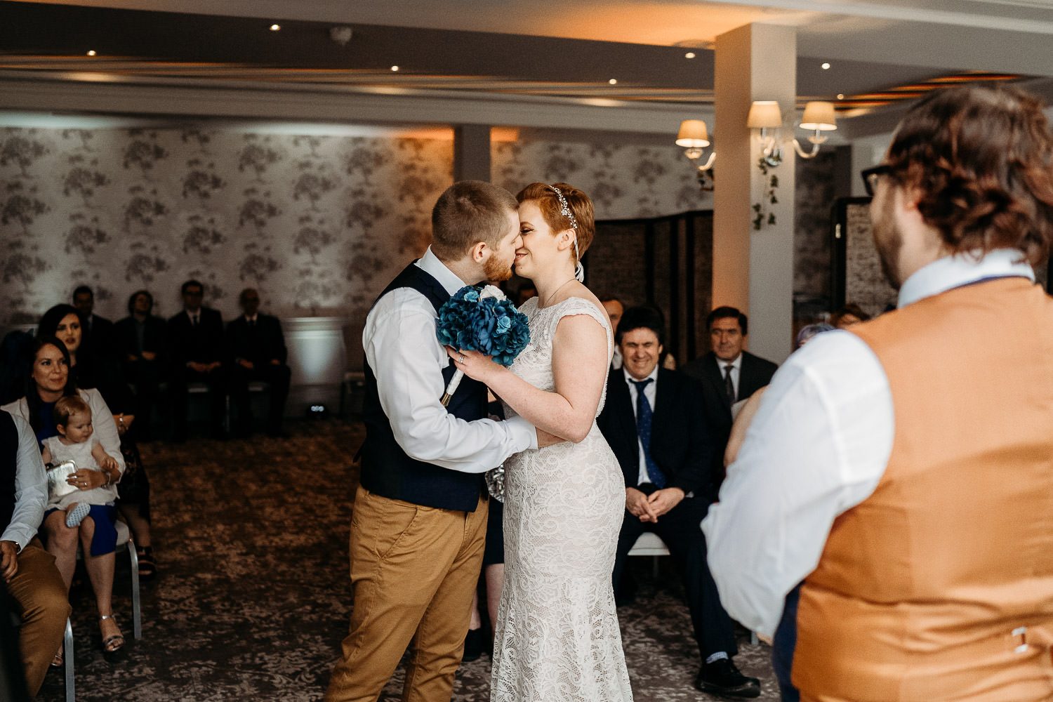 bride and groom having first kiss after humanist wedding ceremony