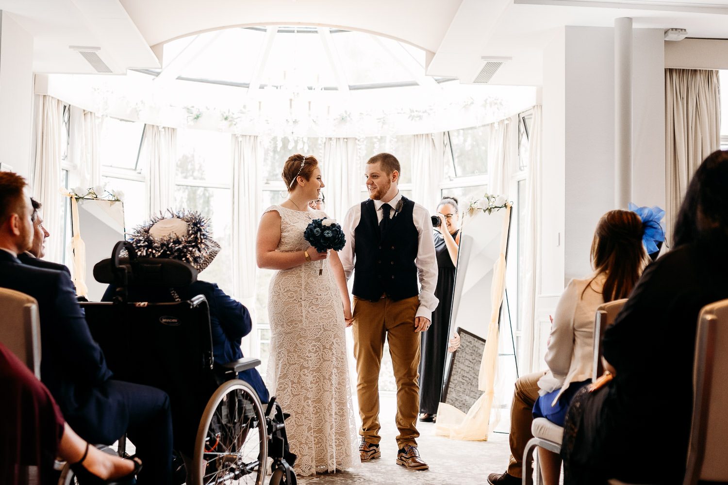 bride and groom walking back down the aisle after wedding ceremony at mercure hotel newbury