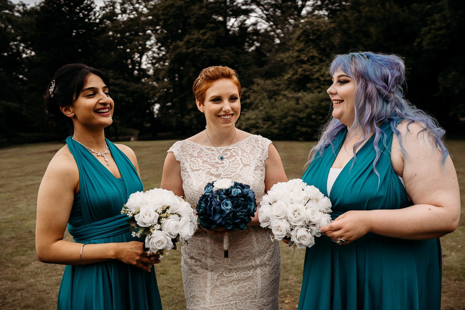 relaxed bride and bridesmaid laughing during group shots