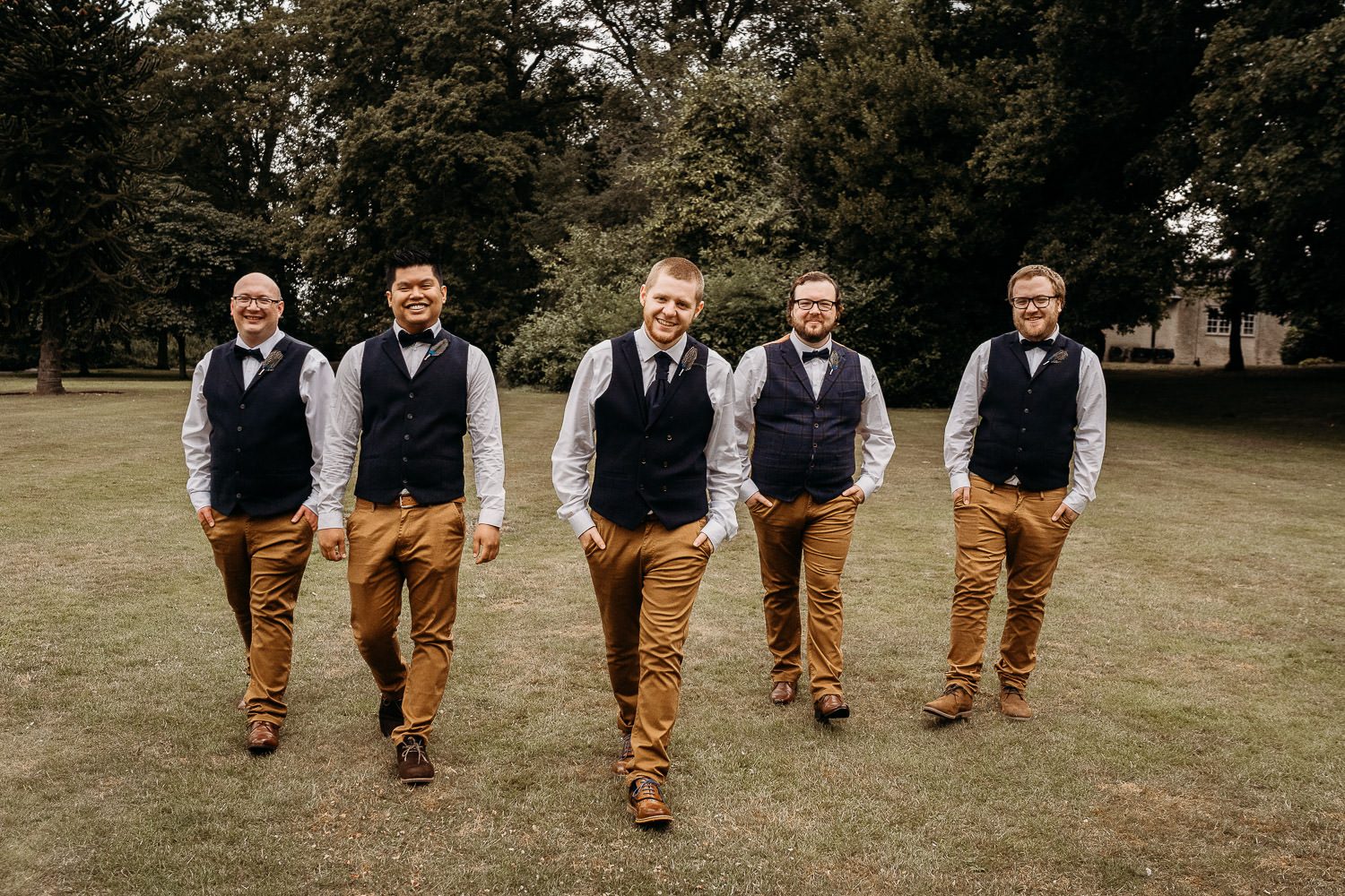 groom and groomsmen walking and laughing candidly