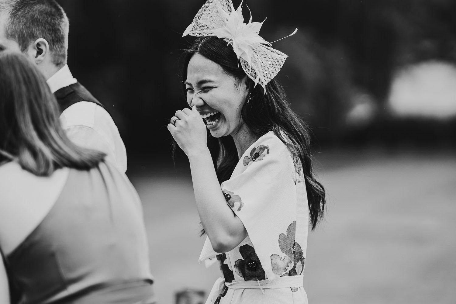 wedding guest laughing candidly during lawn games