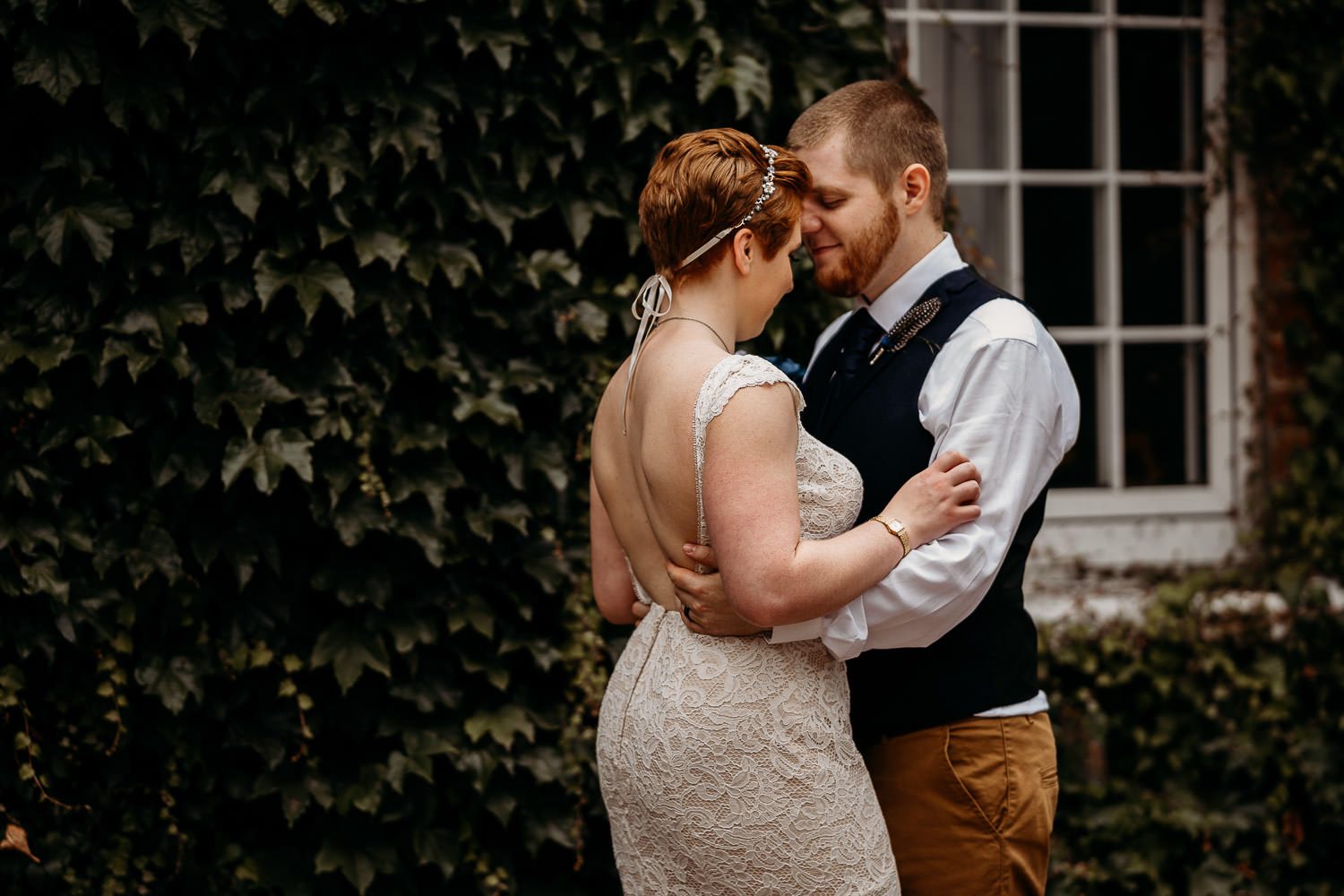 bride and groom holding each other outside of mercure elcot hotel