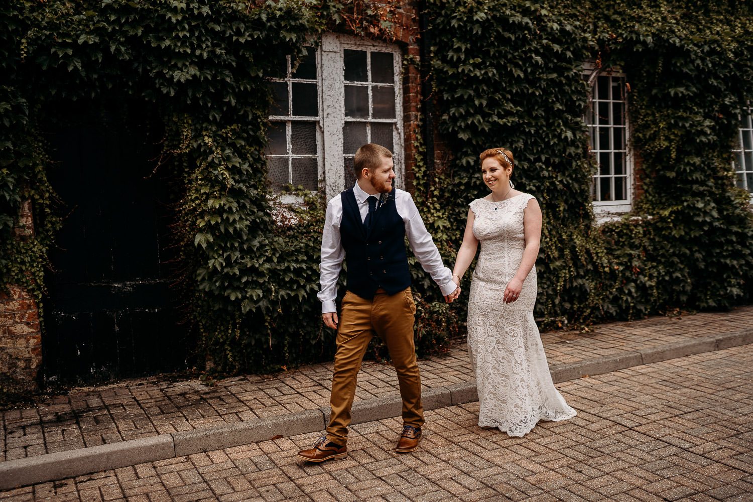 groom walking bride through newbury elcot wedding venue